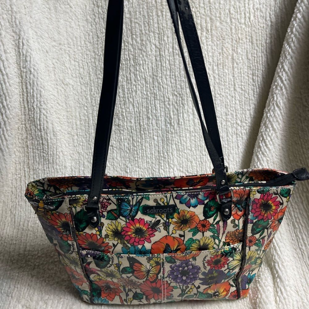 Sakroots Metro tote bag multicolor floral & butterfly pattern coated canvas.